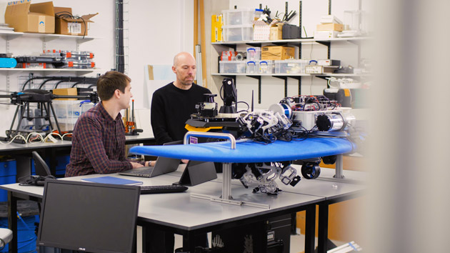 Picture shows Andrew West and Professor Barry Lennox working in the robotics laboratory