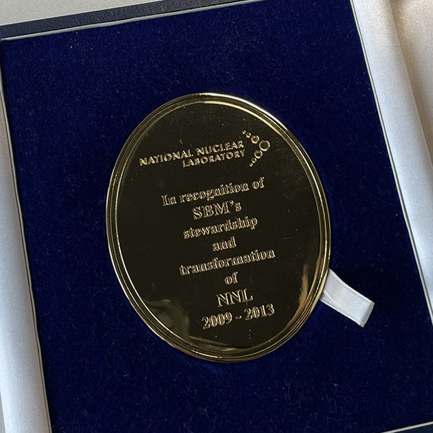Image is of the gold medal presented to the Dalton Nuclear Institute to commemorate its contribution to the formation of the UKNNL: inscribed "In recognition of SBM's stewardship and transformation of NNL 2009-2013"