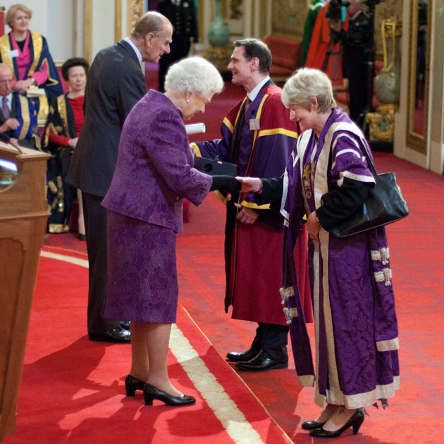 Picture shows Professor Andrew Sherry and Dame Nancy Rothwell receiving the Queen's Anniversary Prize at Buckingham Palace