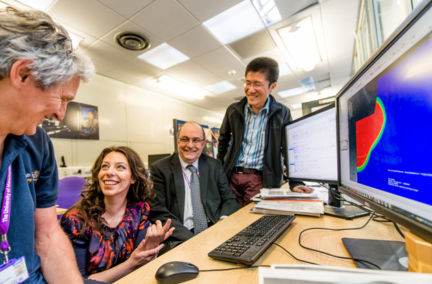 Picture shows Professor Mike C Smith, Anastasia Vasileiou, Steven Bate, Yongle Sun around a computer with a modelling simulation on the screen